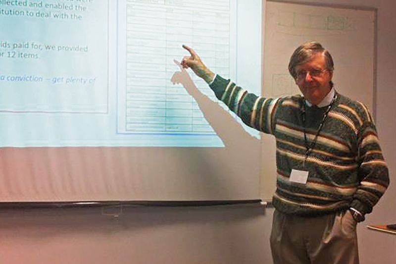 Robert Clarke teaching beside a projected slide